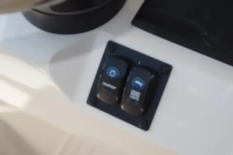 Slide: The Image of Control panel switches on 2021 Stingray 236CC boat dashboard. - 26