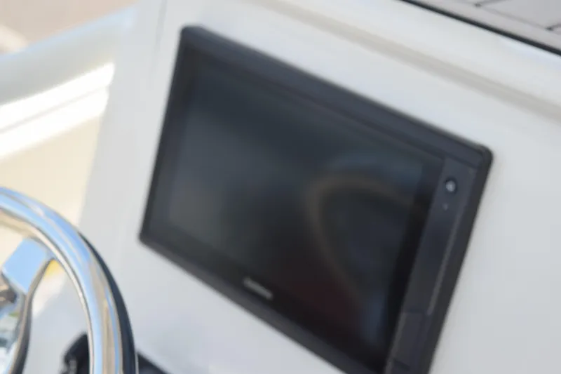 Slide: The Image of Dashboard of 2021 Stingray 236CC boat with steering wheel and display screen. - 27