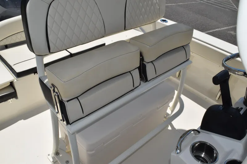 Slide: The Image of 2021 Stingray 236CC boat interior with cushioned seating and cup holders. - 28
