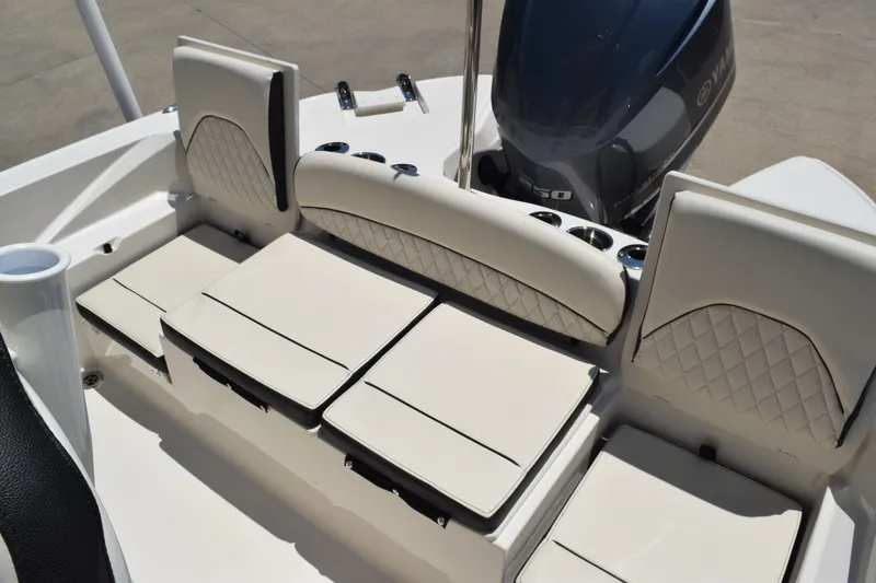 Slide: The Image of 2021 Stingray 236CC boat interior with cushioned seating and Yamaha engine. - 29