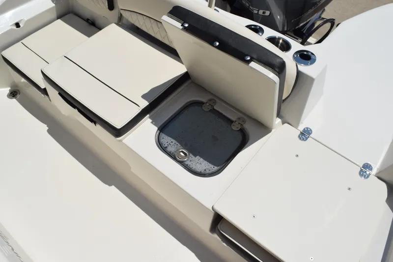 Slide: The Image of 2021 Stingray 236CC boat seating area with storage compartments and cup holders. - 30