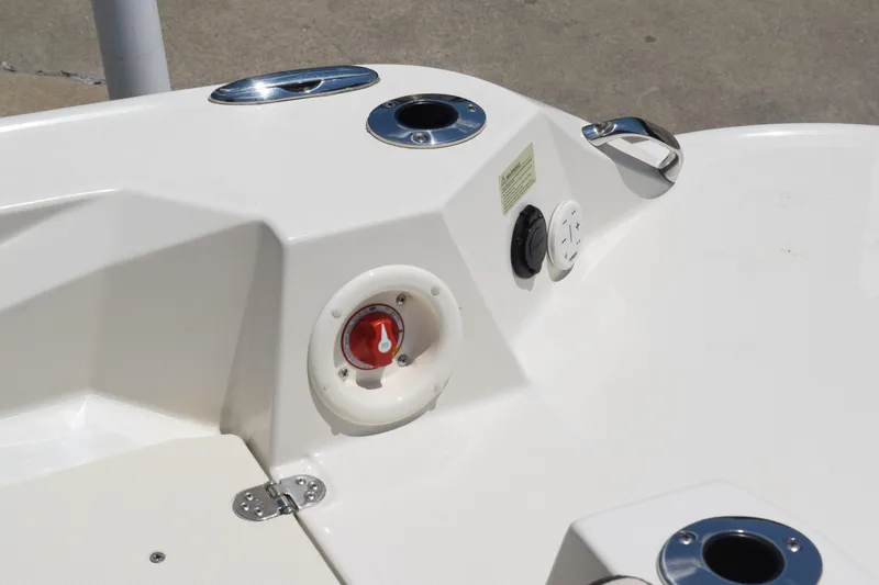 Slide: The Image of 2021 Stingray 236CC boat control panel with switches and cup holder. - 32