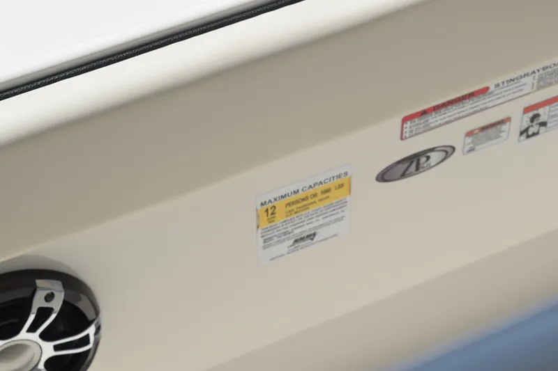 Slide: The Image of 2021 Stingray 236CC boat interior with capacity label and speaker detail. - 37