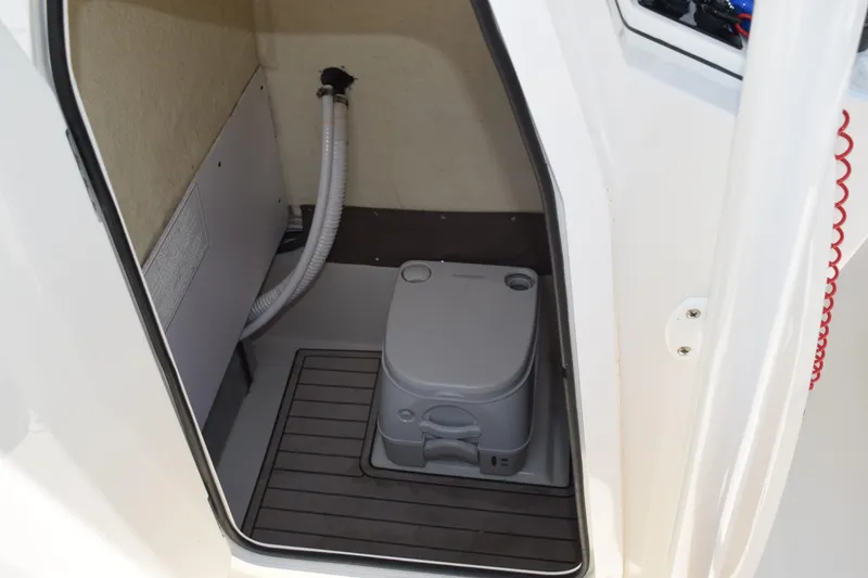Slide: The Image of 2021 Stingray 236CC boat interior with compact marine toilet. - 38