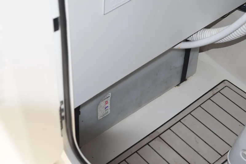 Slide: The Image of Interior view of a 2021 Stingray 236CC boat, showing storage compartment and flooring. - 39
