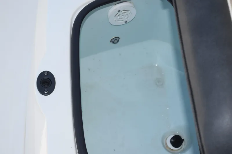 Slide: The Image of Livewell compartment on a 2021 Stingray 236CC boat, featuring drainage and aeration systems. - 40