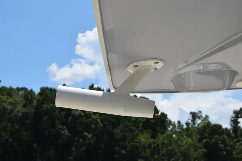 Slide: The Image of 2021 Stingray 236CC boat detail against a clear blue sky and forest background. - 42