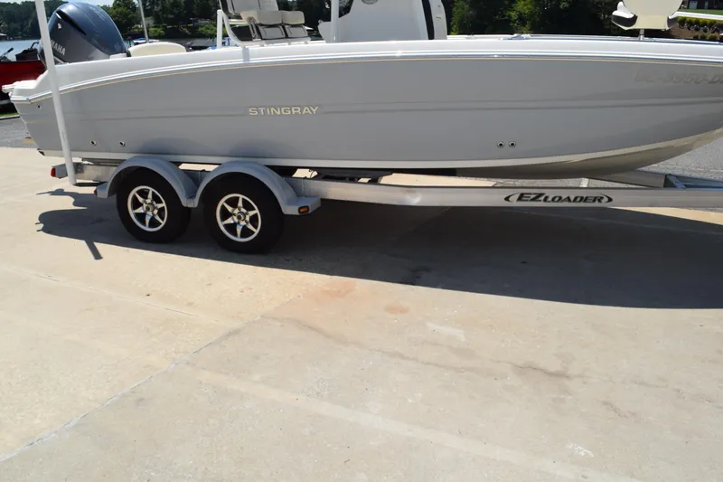 Slide: The Image of 2021 Stingray 236CC boat on EZ Loader trailer, parked outdoors. - 43