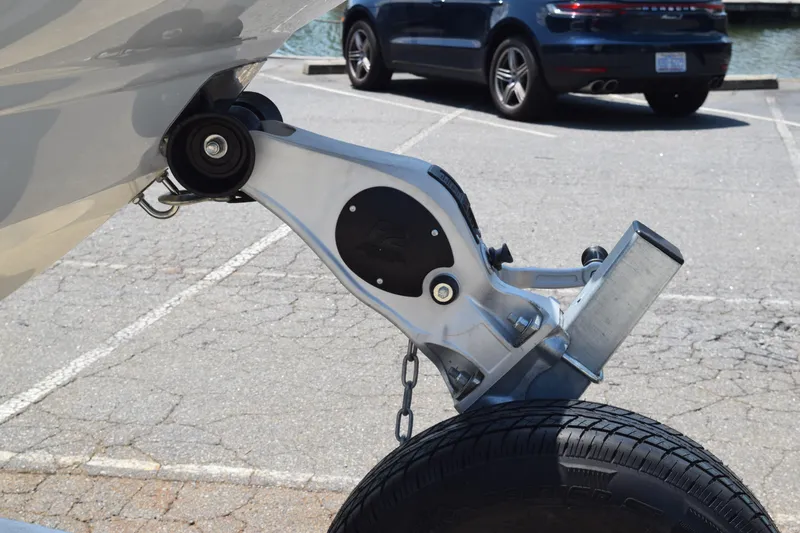 Slide: The Image of Trailer hitch of a 2021 Stingray 236CC boat in a parking lot. - 44