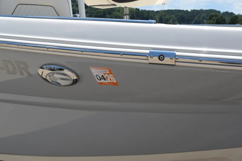 Slide: The Image of 2021 Stingray 236CC boat side view with registration sticker and chrome details. - 45