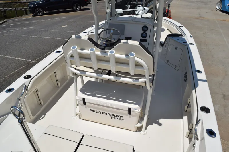 Slide: The Image of 2021 Stingray 236CC boat interior with seating, rod holders, and storage. - 9