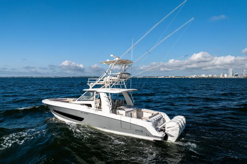 Slide: The Image of 2021 Boston Whaler 420 Outrage cruising on open water under a clear blue sky. - 11