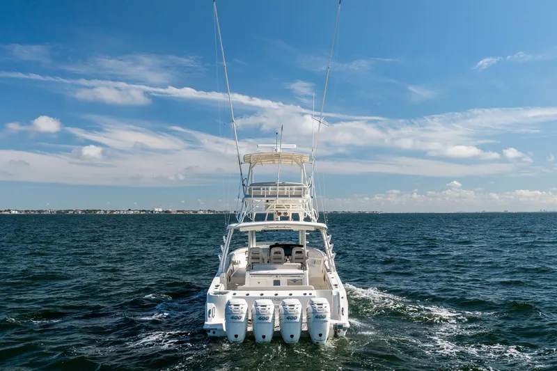 Slide: The Image of 2021 Boston Whaler 420 Outrage cruising on open water under a clear blue sky. - 13