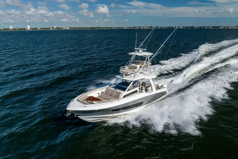Slide: The Image of 2021 Boston Whaler 420 Outrage cruising on open water under a clear sky. - 17