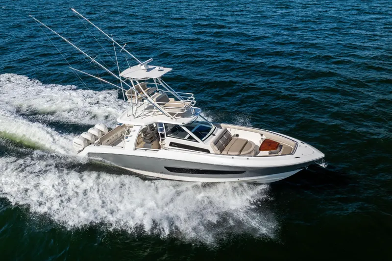 Slide: The Image of 2021 Boston Whaler 420 Outrage cruising on open water, showcasing sleek design and performance. - 19