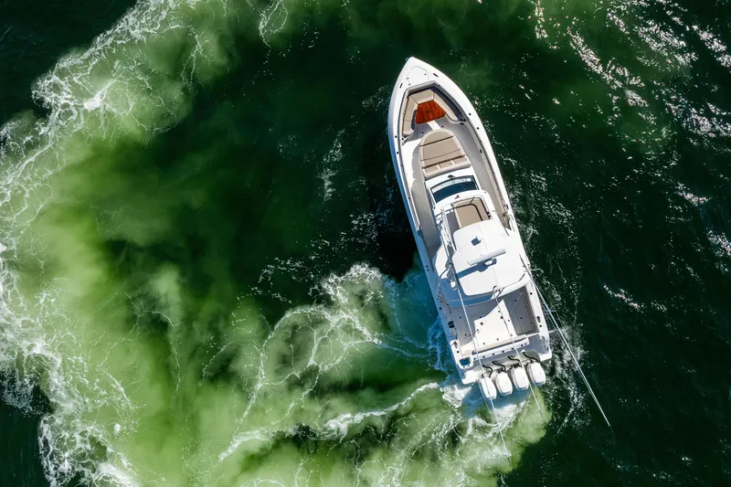 Slide: The Image of Aerial view of 2021 Boston Whaler 420 Outrage cruising through green ocean waters. - 21