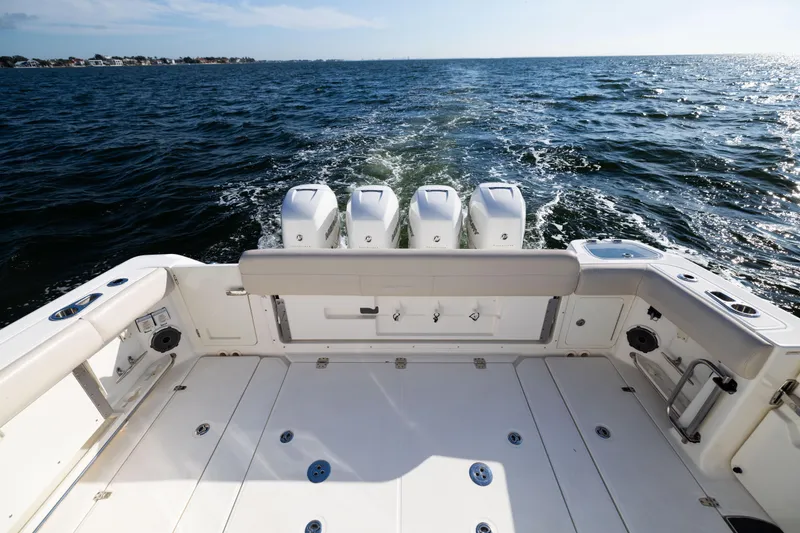 Slide: The Image of 2021 Boston Whaler 420 Outrage boat deck with quad engines on open water. - 22