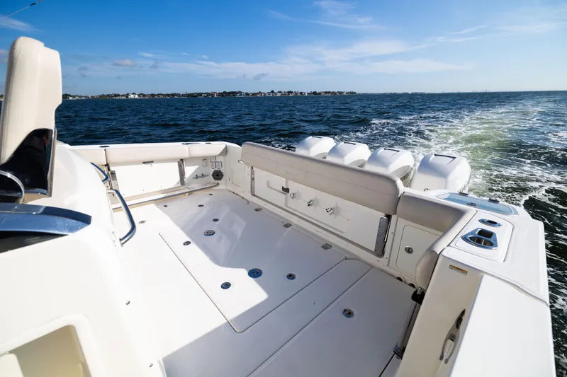 Slide: The Image of 2021 Boston Whaler 420 Outrage boat cruising on open water, showcasing spacious deck. - 24