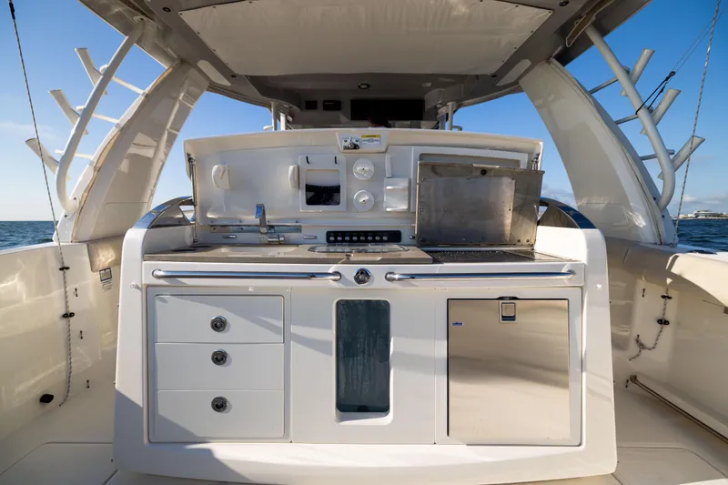 Slide: The Image of 2021 Boston Whaler 420 Outrage boat kitchen area with grill and storage. - 30