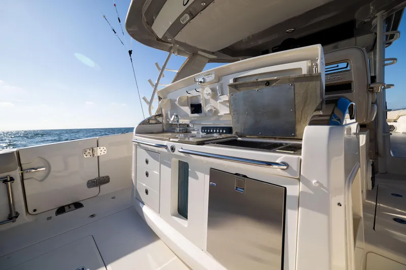 Slide: The Image of 2021 Boston Whaler 420 Outrage boat kitchen area with ocean view. - 31
