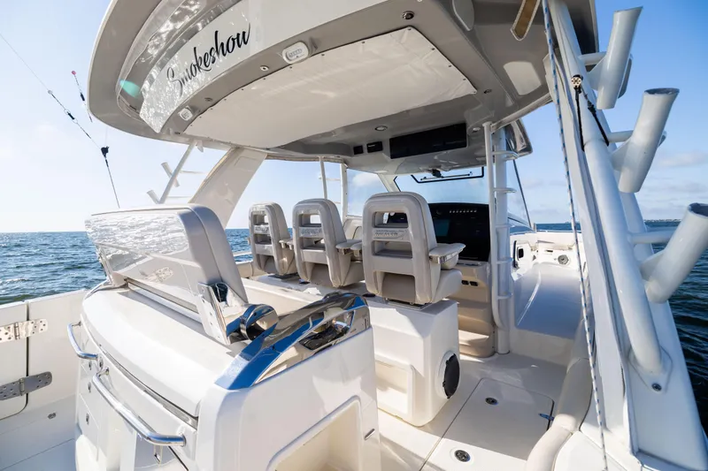 Slide: The Image of 2021 Boston Whaler 420 Outrage boat interior, featuring luxurious seating and ocean view. - 38