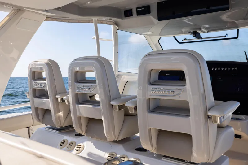 Slide: The Image of 2021 Boston Whaler 420 Outrage helm seats with ocean view. - 40