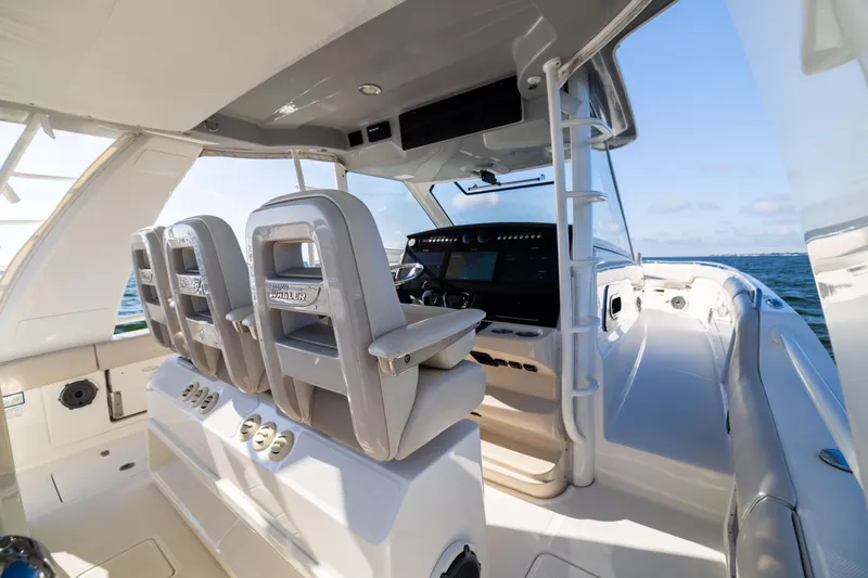 Slide: The Image of 2021 Boston Whaler 420 Outrage boat interior with helm and seating, ocean view. - 41