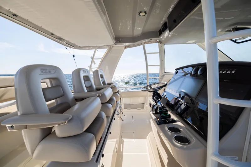 Slide: The Image of Interior of 2021 Boston Whaler 420 Outrage boat with luxurious seating and modern controls. - 42