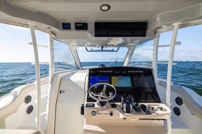 Slide: The Image of 2021 Boston Whaler 420 Outrage helm with advanced navigation system on open water. - 45