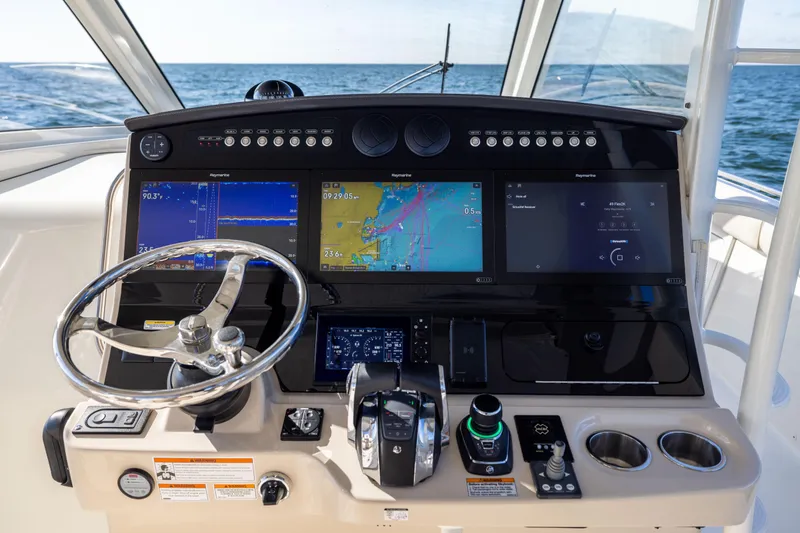 Slide: The Image of Helm of 2021 Boston Whaler 420 Outrage with advanced navigation displays and controls. - 46