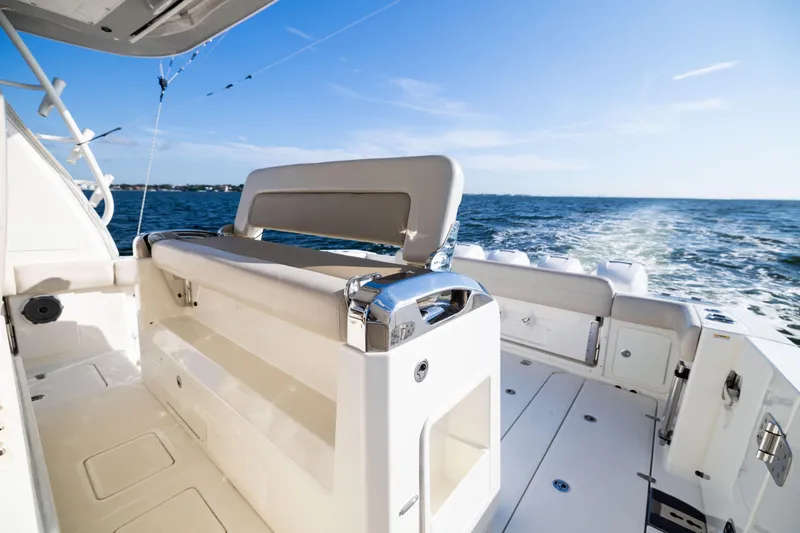 Slide: The Image of 2021 Boston Whaler 420 Outrage boat interior with ocean view and seating area. - 54
