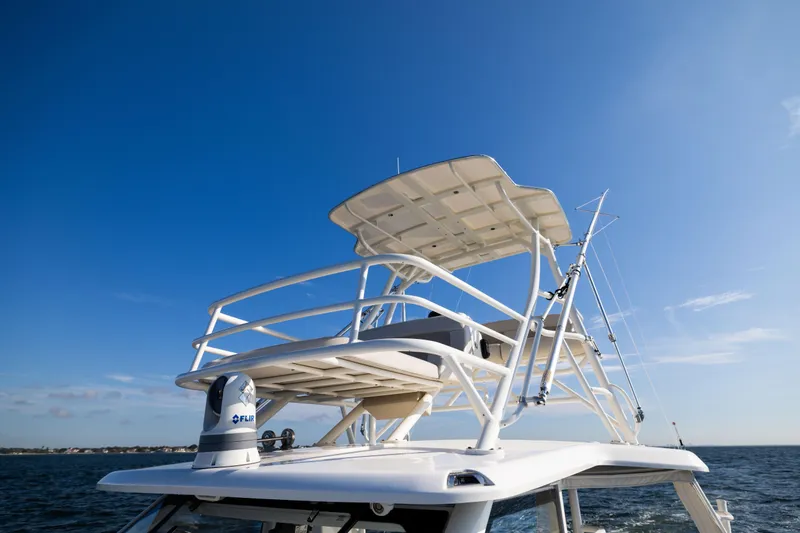 Slide: The Image of Boston Whaler 420 Outrage 2021 boat tower against clear blue sky. - 56