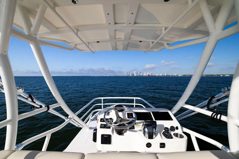 Slide: The Image of Boston Whaler 420 Outrage 2021 helm view with city skyline in the distance. - 59