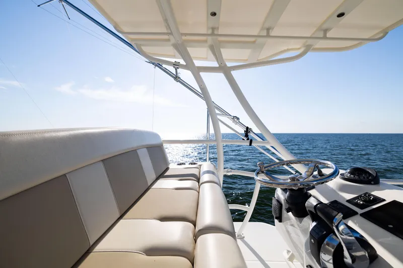 Slide: The Image of 2021 Boston Whaler 420 Outrage helm and seating with ocean view. - 62