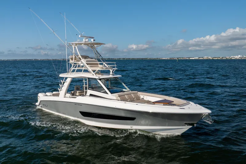 Slide: The Image of 2021 Boston Whaler 420 Outrage cruising on open water under clear skies. - 7