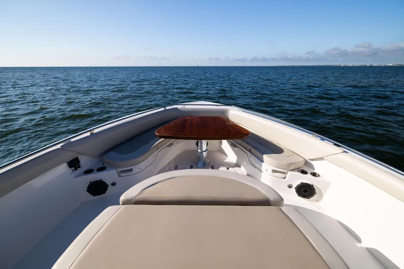 Slide: The Image of 2021 Boston Whaler 420 Outrage boat interior with ocean view, featuring seating and table. - 71