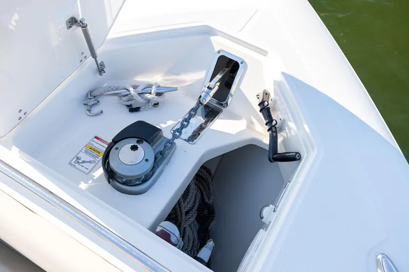 Slide: The Image of 2021 Boston Whaler 420 Outrage anchor compartment with winch and rope storage. - 73