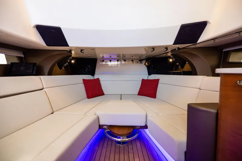 Slide: The Image of Luxurious interior of 2021 Boston Whaler 420 Outrage with white seating and red cushions. - 77