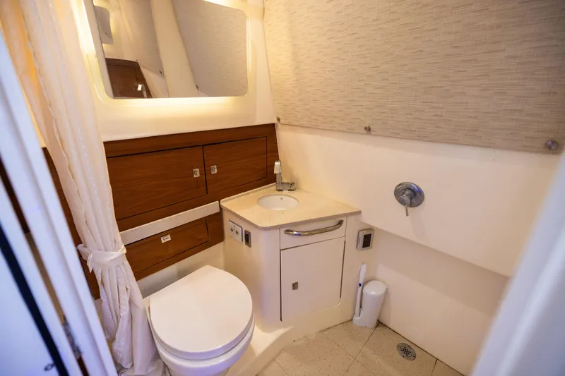 Slide: The Image of Luxurious bathroom in 2021 Boston Whaler 420 Outrage boat, featuring modern fixtures and wood accents. - 81
