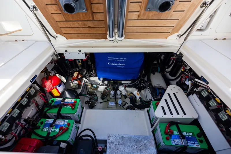 Slide: The Image of 2021 Boston Whaler 420 Outrage engine compartment with batteries and equipment. - 83