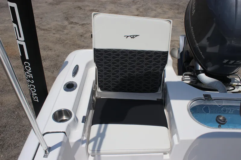 Slide: The Image of 2026 Tidewater 1910 Bay Max boat seat with black and white design, near engine. - 17
