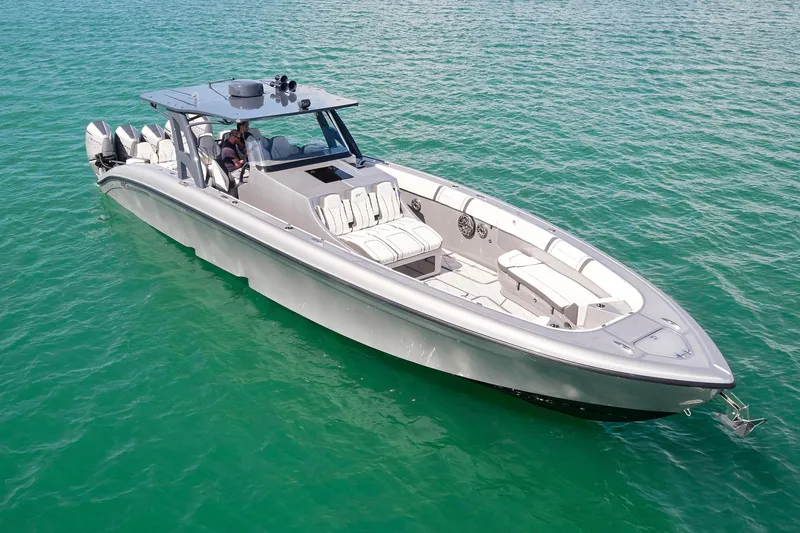 Slide: The Image of 2022 Midnight Express 43 Open boat cruising on clear turquoise water. - 13