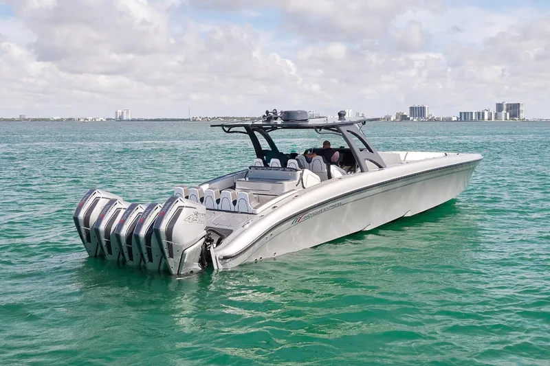 Slide: The Image of 2022 Midnight Express 43 Open boat cruising on turquoise water under a cloudy sky. - 14