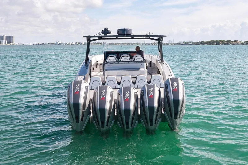 Slide: The Image of 2022 Midnight Express 43 Open boat with five powerful outboard engines on turquoise water. - 16