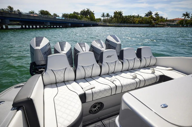 Slide: The Image of 2022 Midnight Express 43 Open boat with multiple engines on a sunny day. - 17