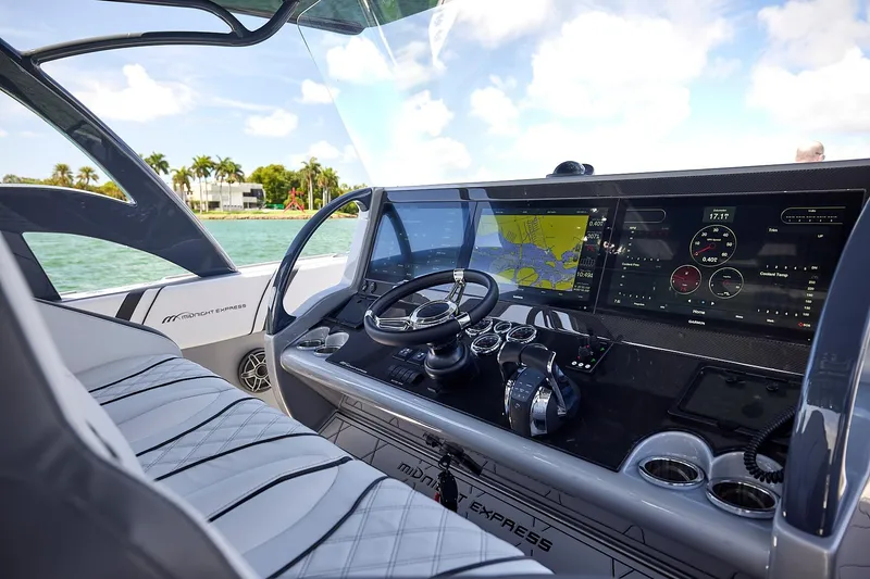 Slide: The Image of Interior view of 2022 Midnight Express 43 Open boat cockpit with advanced navigation system. - 24