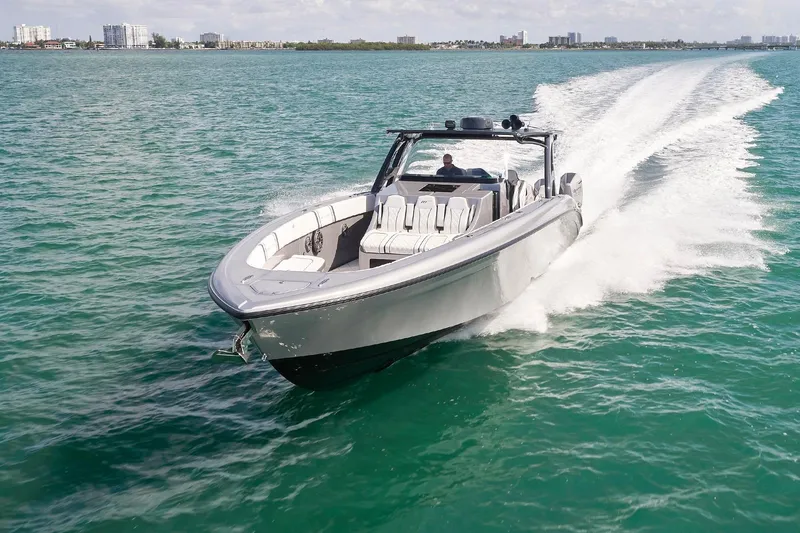 Slide: The Image of 2022 Midnight Express 43 Open boat cruising on clear blue water. - 3