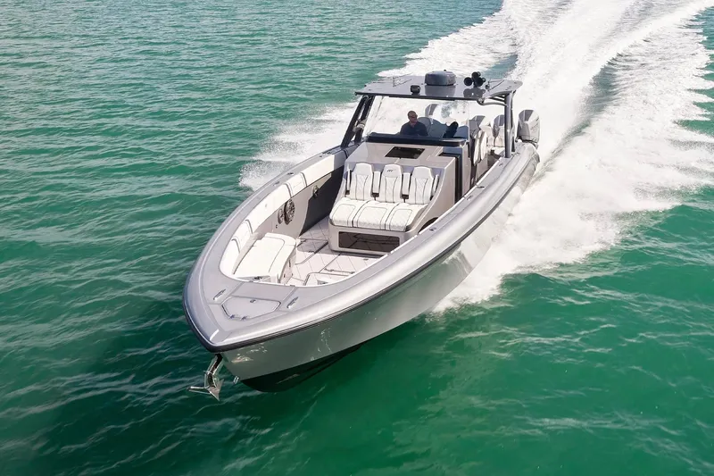 Slide: The Image of 2022 Midnight Express 43 Open boat cruising on clear turquoise water. - 4