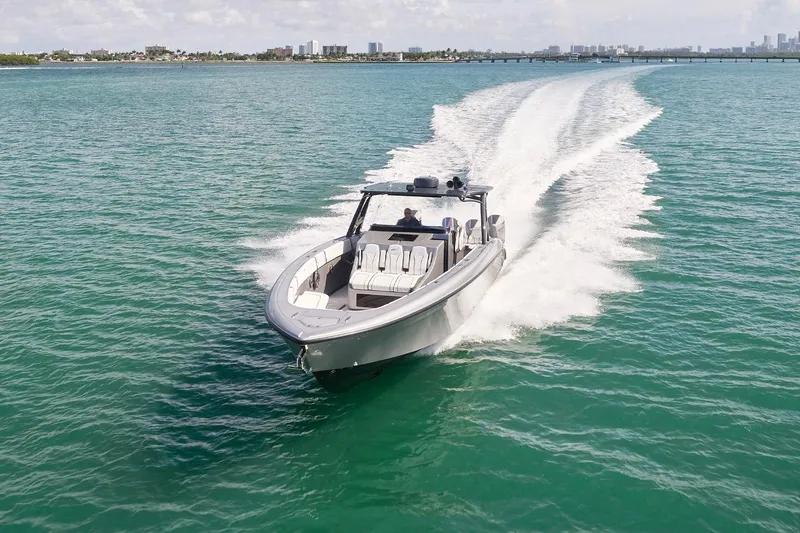 Slide: The Image of 2022 Midnight Express 43 Open boat cruising on clear turquoise waters. - 5