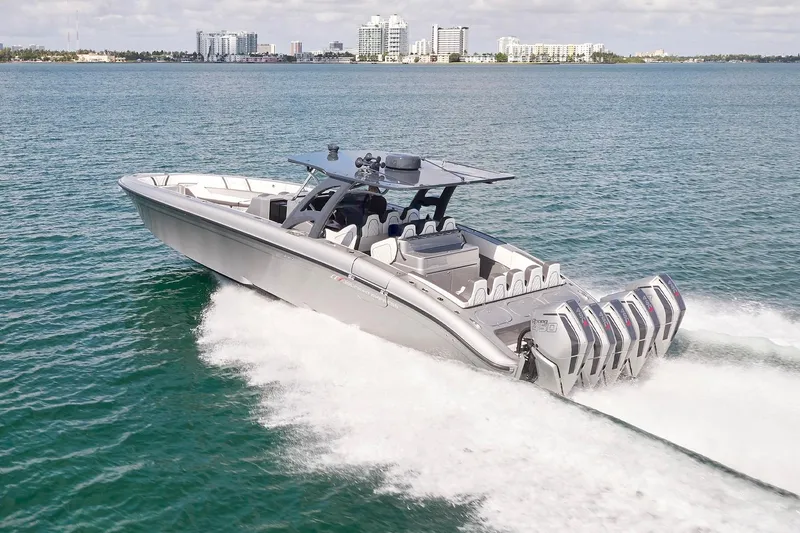 Slide: The Image of 2022 Midnight Express 43 Open boat cruising on water with city skyline in background. - 7